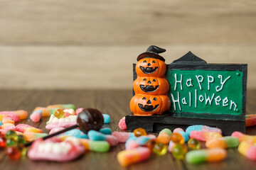 Happy Halloween day with ghost candies, pumpkin bowl, Jack O lantern and decorative (selective focus). Trick or Threat, Hello October, fall autumn, Festive, party and holiday concept