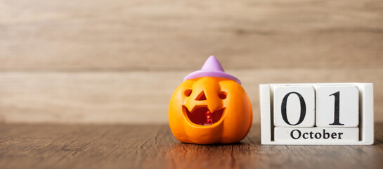 Happy Halloween day with Jack O lantern pumpkin and 1 October calendar. Trick or Threat, Hello October, fall autumn, Festive, party and holiday concept - obrazy, fototapety, plakaty