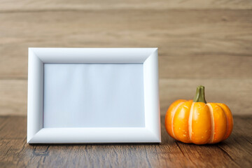 Orange pumpkin on table and frame with copy space for text. Happy Halloween day, Hello October, fall autumn season, Festive, party and holiday concept