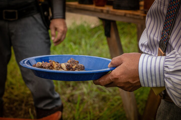 Campfire,meat in plate outdoors camping.adventure camping concept.