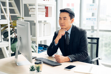 Business professional working with computer on their desks in the office.