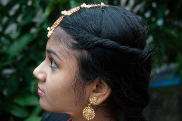 a teenage girl practicing bharatnatyam in nature