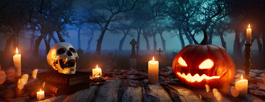 Eerie Background with Jack-O-Lantern, Skull and Candles. Halloween Graveyard Tabletop.