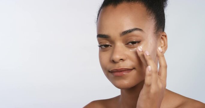 Beauty, makeup and face cosmetics for girl working on facial skincare with natural cream. Black woman using health, wellness and spa skin care product or cream to prevent wrinkles and maintain youth