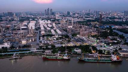 Aerial view oil and gas industry refinery at sunset, Aerial view oil and gas Industrial petrochemical fuel power and energy, Refinery factory oil storage tank and pipeline steel.
