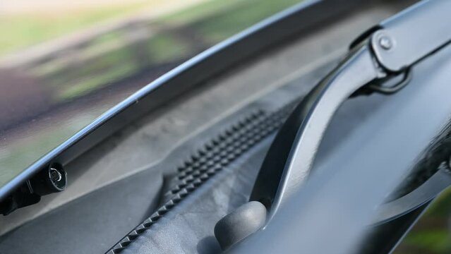 4k video of Under hood windshield washer jet used to spray liquid to clean glass on a vehicle. 