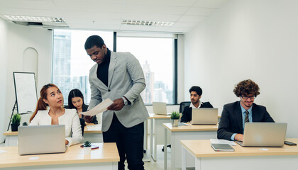 leader or businessman sends documents female colleague in the creative office.