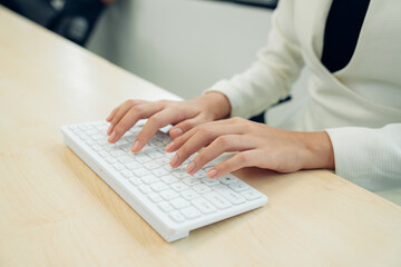 closeup hands of businesswoman working at office, woman typing keyboard on laptop or computer.
