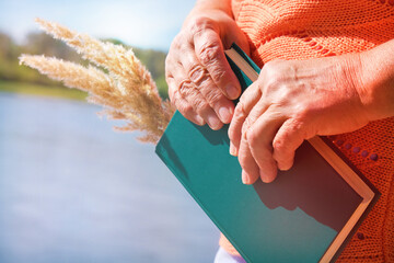 Woman relaxing pensive outdoors and reading book
