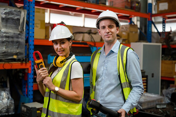 Engineers is controlling robot arm machine welding steel, worker using forcing welding with a control screen which is used for precision welding control.