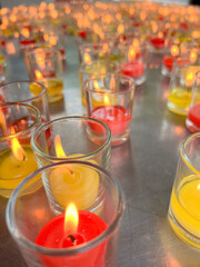 Colorful Candle as red or yellow in small glass