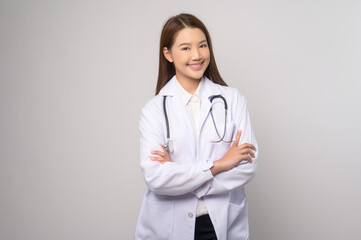 Portrait of female confident doctor over white background studio, healthcare and Medical technology concept.