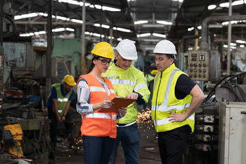 Group of male and female engineer discussing and training about work at the factory. Team of...