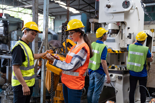 Group of male and female engineer discussing and training about work at the factory. Team of engineer checking and maintaining machines in the factory