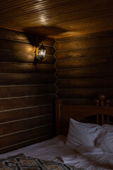 Cozy wooden interior in hotel with white bedsheets and light