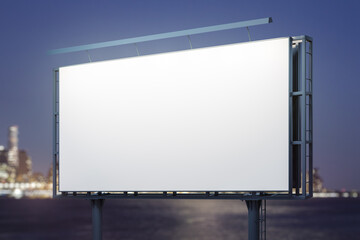 Obraz premium Blank white billboard on cityscape background at evening, perspective view. Mock up, advertising concept