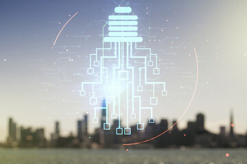 Virtual creative idea concept with light bulb and microcircuit illustration on blurry skyline...