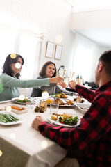 Cheers. Family Christmas gathering. Celebrate toasting with champagne. Raising the glasses. Vertical image. Copy space.