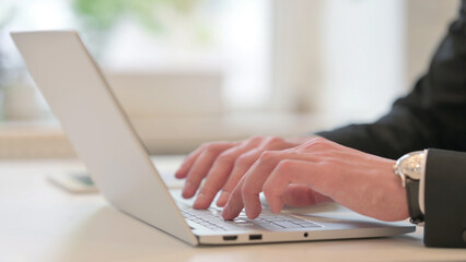 Close up of Hands of Middle Aged Businessman Typing on Laptop