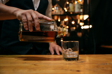 Barman pouring whiskey whiskey glass beautiful night