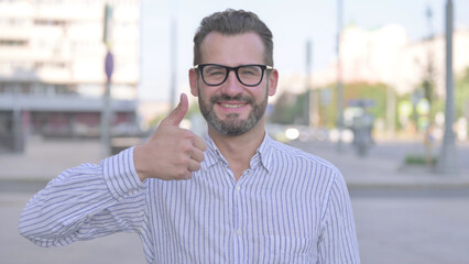 Thumbs Up By Excited Young Adult Man Outdoor