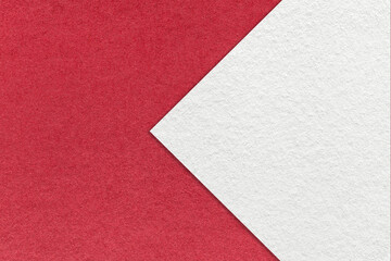 Texture of red paper background, half two colors with white arrow sign, macro. Structure of craft...