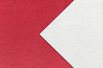 Fototapeta premium Texture of red paper background, half two colors with white arrow sign, macro. Structure of craft ruby cardboard.