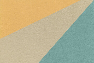 Fototapeta na wymiar Texture of old craft beige, blue and yellow color paper background, macro. Vintage abstract cerulean cardboard.