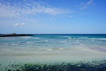 clear shoaling beach and seaside gazebo