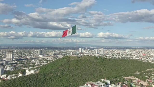 Mexico flag waving on Cerro del Obispado, Monterrey aerial view 3