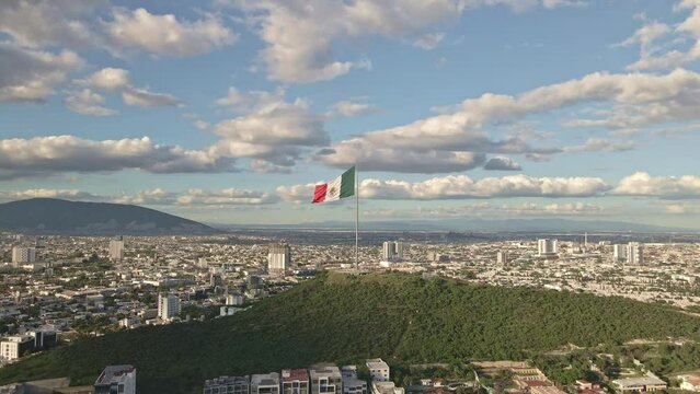 Mexico flag waving on Cerro del Obispado, Monterrey aerial view 4