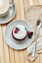 Natural gluten and sugar free berries tender cupcake and cup of coffee. . Cozy breakfast at the terrace