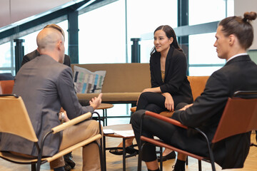 Fototapeta premium Collaborative process of multiethnic business people team working together discussing, researching, brainstorming and planning work at business meeting in modern office building and city background