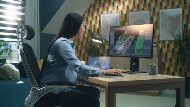 Asian woman designing 3D prototype of electric bass guitar using modern personal computer and tablet in 3D modeling program while working remotely from home