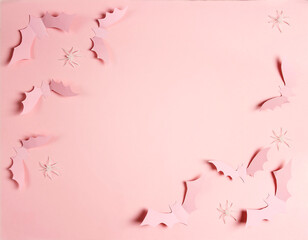 Halloween paper decorations bats and spiders on pastel pink colors.