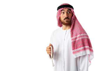 Young Arab man in traditional clothes holding beads isolated on white background