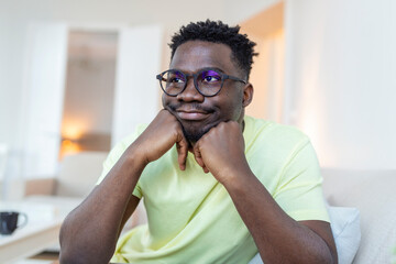 Obraz premium Profile picture of smiling young African American man in glasses pose in own home apartment. Close up headshot portrait of happy millennial biracial male renter or tenant in spectacles show optimism.