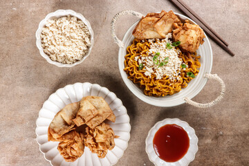 Mie Goreng ala Mie Gacoan is homemade fried noodle topping with chicken shraded and fried dumpling.
