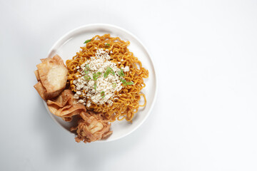 Mie Goreng ala Mie Gacoan is homemade fried noodle topping with chicken shraded and fried dumpling.