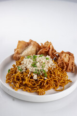 Mie Goreng ala Mie Gacoan is homemade fried noodle topping with chicken shraded and fried dumpling.