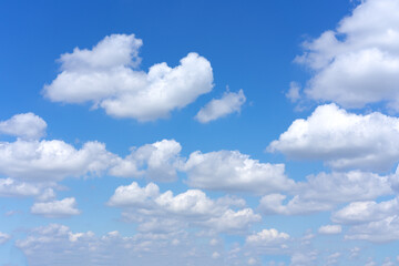 Clear blue sky background with white clouds