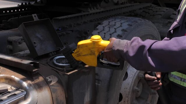 African hand on a old fueling pump, Fueling up a freight transport truck. Dirty auto truck on the road. Commercial vehicle. Truck refuel action close-up Petrol Tanker.
