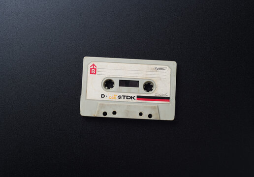 MINSK BELARUS-29.06.2020:TDK D-C90 Audio compact cassette on a black background.Old white vintage audio cassette on a black background, top view.