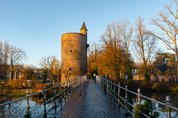 Fototapeta premium Minnewater lake , Minnewaterbrug . Beautiful lake and garden in old town of Brugge during autumn , winter : Brugge , Belgium : November 30 , 2019