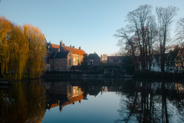 Fototapeta premium Minnewater lake , Minnewaterbrug . Beautiful lake and garden in old town of Brugge during autumn , winter : Brugge , Belgium : November 30 , 2019