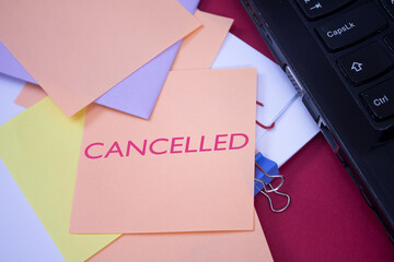 Cancelled. Text on adhesive note paper. Event, celebration reminder message.
