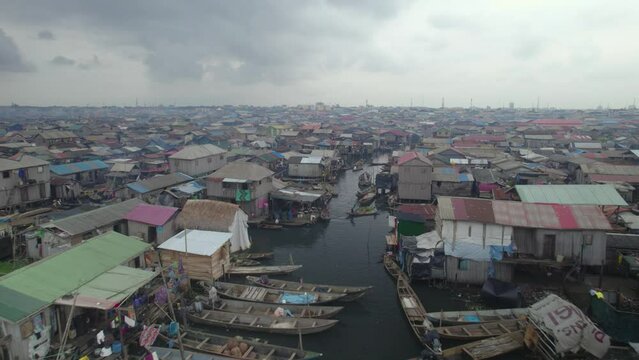 Houses built on a slum with people paddling canoe in Makoko, Lagos, Nigeria