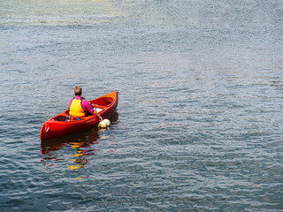 Fototapeta na wymiar Red Canoe In Empty Sea