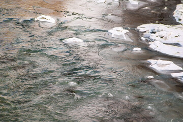 Beautiful winter morning in the forest. River made of ice in winter. Bright rays break through thin fog and tree branches. winter view