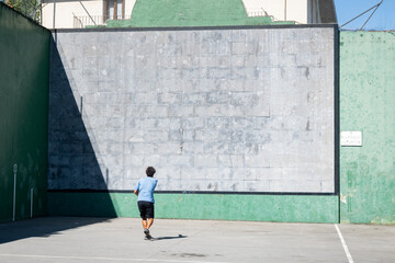 One man practices his hand pelota in a court in Bilbao on a sunny day. The traditional sport uses...